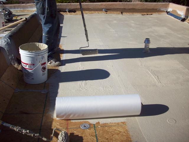 Rolling Out Fabric Into Wet Coatings